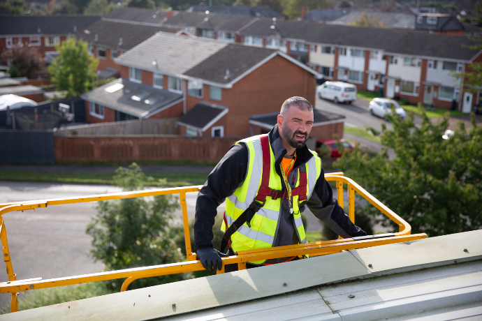 a man on a high-lift in a hi-vis