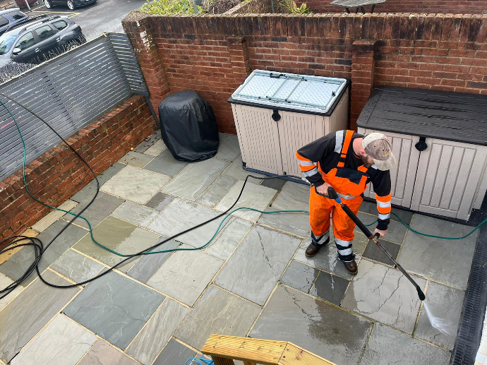 jet washing a patio from above