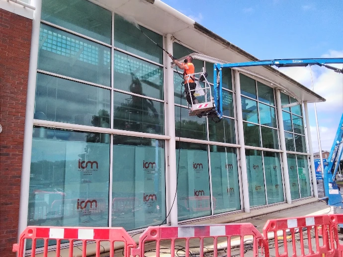 cleaning windows using a long reach arm