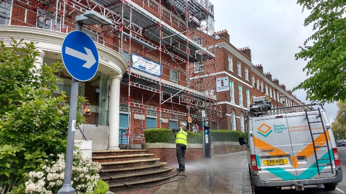 jet washing some steps outside a commercial building