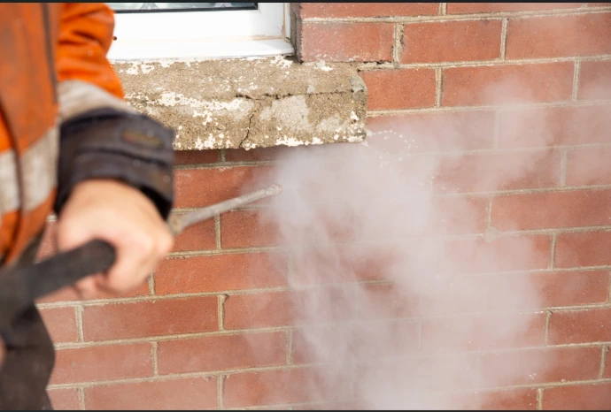 steam cleaning a brick wall