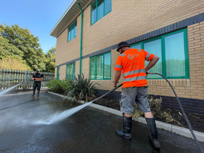 jet washing tarmac outside a commercial building